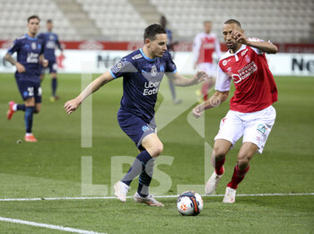 2021-04-23 - Florian Thauvin of Marseille, Yunis Abdelhamid of Reims during the French championship Ligue 1 football match between Stade de Reims and Olympique de Marseille (OM) on April 23, 2021 at Stade Auguste Delaune in Reims, France - Photo Jean Catuffe / DPPI - STADE DE REIMS VS OLYMPIQUE DE MARSEILLE (OM) - FRENCH LIGUE 1 - SOCCER