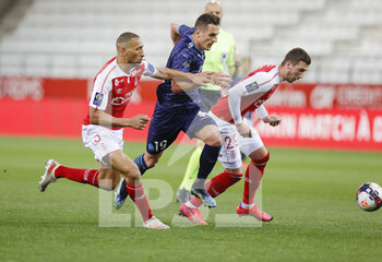 2021-04-23 - Arkadiusz Milik of OM and Yunis Abdelhamid, Dario Maresic of Reims during the French championship Ligue 1 football match between Stade de Reims and Olympique de Marseille on April 23, 2021 at Auguste Delaune stadium in Reims, France - Photo Loic Baratoux / DPPI - STADE DE REIMS VS OLYMPIQUE DE MARSEILLE (OM) - FRENCH LIGUE 1 - SOCCER