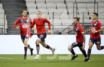2021-04-25 - Burak Yilmaz of Lille celebrates his winning goal with Yusuf Yazici, Xeka, Luiz Araujo during the French championship Ligue 1 football match between Olympique Lyonnais (OL) and Lille OSC (LOSC) on April 25, 2021 at Groupama Stadium in Decines near Lyon, France - Photo Jean Catuffe / DPPI - OLYMPIQUE LYONNAIS (OL) VS LILLE OSC (LOSC) - FRENCH LIGUE 1 - SOCCER