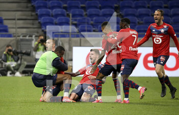 2021-04-25 - Burak Yilmaz of Lille (left) celebrates his winning goal with Xeka and teammates during the French championship Ligue 1 football match between Olympique Lyonnais (OL) and Lille OSC (LOSC) on April 25, 2021 at Groupama Stadium in Decines near Lyon, France - Photo Jean Catuffe / DPPI - OLYMPIQUE LYONNAIS (OL) VS LILLE OSC (LOSC) - FRENCH LIGUE 1 - SOCCER
