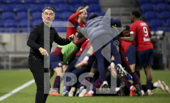 2021-04-25 - Coach of Lille OSC Christophe Galtier looks on while his players celebrate the winning goal during the French championship Ligue 1 football match between Olympique Lyonnais (OL) and Lille OSC (LOSC) on April 25, 2021 at Groupama Stadium in Decines near Lyon, France - Photo Jean Catuffe / DPPI - OLYMPIQUE LYONNAIS (OL) VS LILLE OSC (LOSC) - FRENCH LIGUE 1 - SOCCER