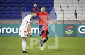 2021-04-25 - Burak Yilmaz of Lille celebrates his winning goal while Mattia De Sciglio of Lyon looks down during the French championship Ligue 1 football match between Olympique Lyonnais (OL) and Lille OSC (LOSC) on April 25, 2021 at Groupama Stadium in Decines near Lyon, France - Photo Jean Catuffe / DPPI - OLYMPIQUE LYONNAIS (OL) VS LILLE OSC (LOSC) - FRENCH LIGUE 1 - SOCCER
