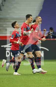 2021-05-01 - Burak Yilmaz of Lille (right) celebrates his goal with Luiz Araujo, Jose Fonte during the French championship Ligue 1 football match between Lille OSC (LOSC) and OGC Nice (OGCN) on May 1, 2021 at Stade Pierre Mauroy in Villeneuve-d'Ascq near Lille, France - Photo Jean Catuffe / DPPI - LILLE OSC (LOSC) VS OGC NICE (OGCN) - FRENCH LIGUE 1 - SOCCER