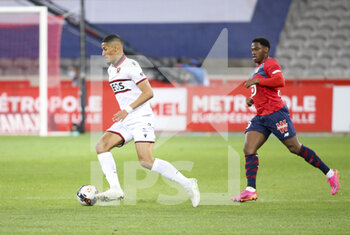 2021-05-01 - William Saliba of Nice, Jonathan David of Lille during the French championship Ligue 1 football match between Lille OSC (LOSC) and OGC Nice (OGCN) on May 1, 2021 at Stade Pierre Mauroy in Villeneuve-d'Ascq near Lille, France - Photo Jean Catuffe / DPPI - LILLE OSC (LOSC) VS OGC NICE (OGCN) - FRENCH LIGUE 1 - SOCCER