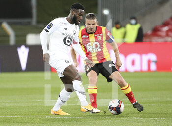 2021-05-07 - Jonathan Bamba of Lille, Yannick Cahuzac of Lens during the French championship Ligue 1 football match between RC Lens and Lille OSC (LOSC) on May 7, 2021 at Stade Bollaert-Delelis in Lens, France - Photo Jean Catuffe / DPPI - RC LENS VS LOSC - FRENCH LIGUE 1 - SOCCER