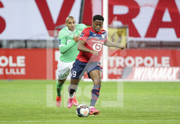 2021-05-16 - Jonathan David of Lille, Wahbi Khazri of Saint-Etienne (left) during the French championship Ligue 1 football match between Lille OSC (LOSC) and AS Saint-Etienne (ASSE) on May 16, 2021 at Stade Pierre Mauroy in Villeneuve-d'Ascq near Lille, France - Photo Jean Catuffe / DPPI - LILLE OSC (LOSC) VS AS SAINT-ETIENNE (ASSE) - FRENCH LIGUE 1 - SOCCER