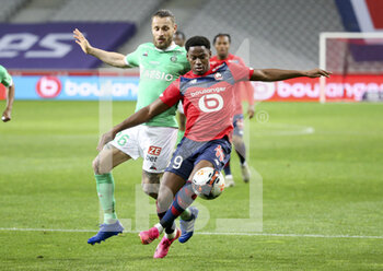 2021-05-16 - Jonathan David of Lille, Mathieu Debuchy of Saint-Etienne (left) during the French championship Ligue 1 football match between Lille OSC (LOSC) and AS Saint-Etienne (ASSE) on May 16, 2021 at Stade Pierre Mauroy in Villeneuve-d'Ascq near Lille, France - Photo Jean Catuffe / DPPI - LILLE OSC (LOSC) VS AS SAINT-ETIENNE (ASSE) - FRENCH LIGUE 1 - SOCCER