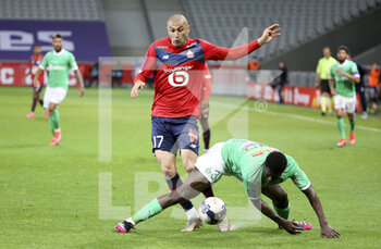 2021-05-16 - Burak Yilmaz of Lille, Saidou Sow of Saint-Etienne during the French championship Ligue 1 football match between Lille OSC (LOSC) and AS Saint-Etienne (ASSE) on May 16, 2021 at Stade Pierre Mauroy in Villeneuve-d'Ascq near Lille, France - Photo Jean Catuffe / DPPI - LILLE OSC (LOSC) VS AS SAINT-ETIENNE (ASSE) - FRENCH LIGUE 1 - SOCCER
