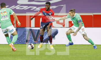 2021-05-16 - Jonathan Bamba of LOSC and Mathieu Debuchy of Saint-Etienne during the French championship Ligue 1 football match between LOSC Lille and AS Saint-Etienne on May 16, 2021 at Pierre Mauroy stadium in Villeneuve-d'Ascq near Lille, France - Photo Loic Baratoux / DPPI - LOSC LILLE VS AS SAINT-ETIENNE - FRENCH LIGUE 1 - SOCCER