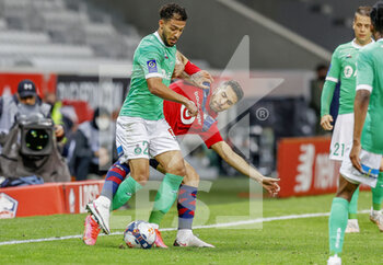 2021-05-16 - Denis Bouanga of Saint-Etienne and Zeki Celik of LOSC during the French championship Ligue 1 football match between LOSC Lille and AS Saint-Etienne on May 16, 2021 at Pierre Mauroy stadium in Villeneuve-d'Ascq near Lille, France - Photo Loic Baratoux / DPPI - LOSC LILLE VS AS SAINT-ETIENNE - FRENCH LIGUE 1 - SOCCER