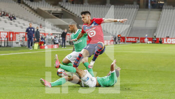 2021-05-16 - Luiz Araujo of LOSC tackled by Denis Bouanga of Saint-Etienne during the French championship Ligue 1 football match between LOSC Lille and AS Saint-Etienne on May 16, 2021 at Pierre Mauroy stadium in Villeneuve-d'Ascq near Lille, France - Photo Loic Baratoux / DPPI - LOSC LILLE VS AS SAINT-ETIENNE - FRENCH LIGUE 1 - SOCCER