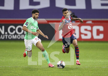 2021-05-16 - Mahdi Camara of Saint-Etienne, Reinildo Mandava of Lille during the French championship Ligue 1 football match between Lille OSC (LOSC) and AS Saint-Etienne (ASSE) on May 16, 2021 at Stade Pierre Mauroy in Villeneuve-d'Ascq near Lille, France - Photo Jean Catuffe / DPPI - LOSC LILLE VS AS SAINT-ETIENNE - FRENCH LIGUE 1 - SOCCER