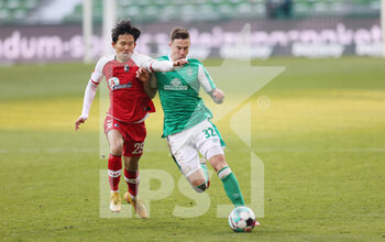 2021-02-13 - Woo-yeong Jeong of Freiburg and Marco Friedl of Werder Bremen during the German championship Bundesliga football match between SV Werder Bremen and SC Freiburg on February 13, 2021 at Weserstadion in Bremen, Germany - Photo Jurgen Fromme / firo Sportphoto / DPPI - SV WERDER BREMEN AND SC FREIBURG - GERMAN BUNDESLIGA - SOCCER