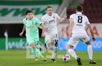 2021-03-12 - Jonas Hofmann of Borussia Moenchengladbach and Andre Hahn of Augsburg during the German championship Bundesliga football match between FC Augsburg and VfL Borussia Moenchengladbach on March 12, 2021 at WWK Arena in Augsburg, Germany - Photo Marcel Engelbrecht / firo Sportphoto / DPPI - FC AUGSBURG AND VFL BORUSSIA MOENCHENGLADBACH - GERMAN BUNDESLIGA - SOCCER
