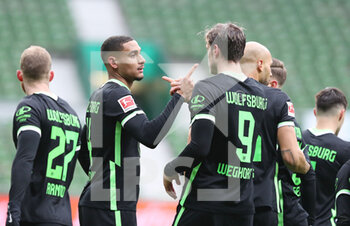 2021-03-17 - Maxence Lacroix of Wolfsburg celebrates with Wout Weghorst after the 0-1 goal during the German championship Bundesliga football match between SV Werder Bremen and VfL Wolfsburg on March 20, 2021 at the Weserstadion in Bremen, Germany - Photo Sebastian El-Saqqa / firo sportphoto / DPPI - SV WERDER BREMEN AND VFL WOLFSBURG - GERMAN BUNDESLIGA - SOCCER