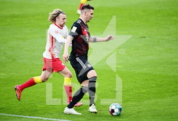 2021-04-03 - Niklas Suele of Bayern Munich and Emil Forsberg of RB Leipzig during the German championship Bundesliga football match between RB Leipzig and Bayern Munich on April 3, 2021 at Red Bull Arena in Leipzig, Germany - Photo Valeria Witters / Witters / firo sportphoto / DPPI - RB LEIPZIG VS BAYERN MUNICH - GERMAN BUNDESLIGA - SOCCER