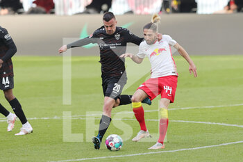 2021-04-25 - Kevin Kampl of RB Leipzig and Philipp Forster of Stuttgart during the German championship Bundesliga football match between Red Bull Leipzig and VfB Stuttgart on April 25, 2021 at Red Bull Arena in Leipzig, Germany - Photo Ralf Ibing / firo Sportphoto / DPPI - RED BULL LEIPZIG VS VFB STUTTGART - GERMAN BUNDESLIGA - SOCCER
