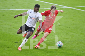 2021-05-08 - Thomas Mueller of Bayern Munich and Breel Embolo of Borussia Moenchengladbach during the German championship Bundesliga football match between Bayern Munich and Borussia Moenchengladbach on May 8, 2021 at Allianz Arena in Munich, Germany - Photo Lennart Preiss / Witters / firo sportphoto / DPPI - BAYERN MUNICH VS BORUSSIA MOENCHENGLADBACH - GERMAN BUNDESLIGA - SOCCER