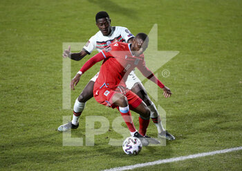 2021-03-30 - Christopher Martins of Luxembourg, Nuno Mendes of Portugal during the 2022 FIFA World Cup, Qualifiers, Group A football match between Luxembourg and Portugal on March 30, 2021 at Josy Barthel in Luxembourg, Luxembourg - Photo Jean Catuffe / DPPI - MONDIALI FIFA 2022, QUALIFICAZIONI, GRUPPO A - LUSSEMBURGO VS PORTOGALLO - FIFA WORLD CUP - SOCCER
