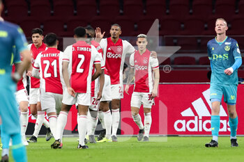 2021-02-21 - Sebastien Haller of Ajax celebrates with his team mates after scoring his sides first goal during the Netherlands championship Eredivisie football match between Ajax and Sparta Rotterdam on February 21, 2021 at Johan Cruijff ArenA in Amsterdam, Netherlands - Photo Ben Gal / Orange Pictures / DPPI - AJAX AND SPARTA ROTTERDAM - NETHERLANDS EREDIVISIE - SOCCER