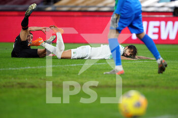 2020-12-06 - Gian Marco Ferrari of Sassuolo goes down after a challange by Henrikh Mkhitaryan of Roma during the Italian championship Serie A football match between AS Roma and US Sassuolo Calcio on December 6, 2020 at Stadio Olimpico in Rome, Italy - Photo Federico Proietti / DPPI - AS ROMA VS US SASSUOLO CALCIO - ITALIAN SERIE A - SOCCER