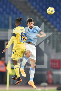 2020-12-12 - ROME, ITALY - December 12 Adien Tameze (L) of Hellas Verona in action against  Francesco Acerbi (R) of Lazio during the Serie A soccer match between SS Lazio and Hellas Verona Stadio Olimpico on December 12,2020 in Rome Italy   - SS LAZIO VS HELLAS VERONA - ITALIAN SERIE A - SOCCER