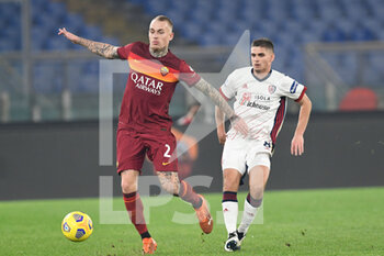 2020-12-23 - ROME, ITALY - December 23 : Rick Karsdorp (L) of AS Roma in action against RazvanMarin (R) of Cagliari during the Serie A soccer match between AS Roma and Cagliari at Stadio Olimpico on December 23,2020 in Rome Italy  - ROMA VS CAGLIARI - ITALIAN SERIE A - SOCCER