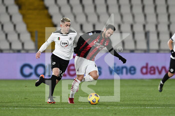 2021-02-13 - Hakan Calhanoglu of AC Milan in action against Nahuel Estevez of AC Spezia  - SPEZIA CALCIO VS AC MILAN - ITALIAN SERIE A - SOCCER