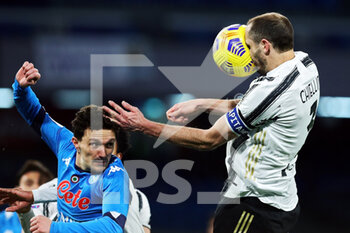 2021-02-13 - Giorgio Chiellini of Juventus (R) goes for a header with Mario Rui of Napoli (L) during the Italian championship Serie A football match between SSC Napoli and Juventus FC on February 13, 2021 at Diego Armando Maradona Stadium in Naples, Italy - Photo Federico Proietti / DPPI - SSC NAPOLI AND JUVENTUS FC - ITALIAN SERIE A - SOCCER