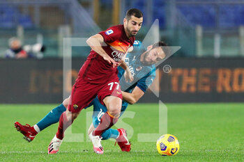 2021-02-28 - Hakan Calhanoglu of Milan (R) fights for the ball with Henrikh Mkhitaryan of Roma (L) during the Italian championship Serie A football match between AS Roma and AC Milan on February 28, 2021 at Stadio Olimpico in Rome, Italy - Photo Federico Proietti / DPPI - AS ROMA AND AC MILAN - ITALIAN SERIE A - SOCCER