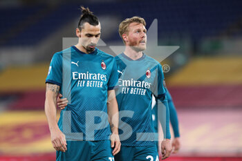 2021-02-28 - Zlatan Ibrahimovic (L) and Simon Kjaer (R) of Milan react during the Italian championship Serie A football match between AS Roma and AC Milan on February 28, 2021 at Stadio Olimpico in Rome, Italy - Photo Federico Proietti / DPPI - AS ROMA AND AC MILAN - ITALIAN SERIE A - SOCCER