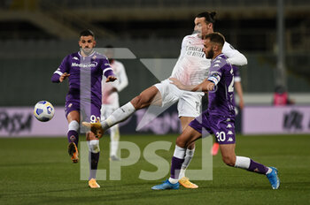 2021-03-21 - Zlatan Ibrahimovic of AC Milan in action against German Pezzella of ACF Fiorentina  - ACF FIORENTINA VS AC MILAN - ITALIAN SERIE A - SOCCER