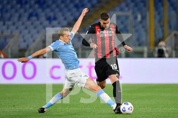 2021-04-26 - Theo Hernandez of AC Milan and Lucas Leiva of SS Lazio seen in action during the Italian Football Championship League A 2020/2021 match between SS Lazio vs AC Milan at the Olimpic Stadium in Rome. - SS LAZIO VS AC MILAN - ITALIAN SERIE A - SOCCER