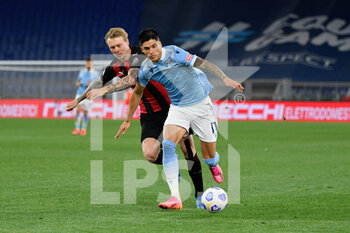 2021-04-26 - Joaquin Correa of SS Lazio and Simon Kjaer of AC Milan seen in action during the Italian Football Championship League A 2020/2021 match between SS Lazio vs AC Milan at the Olimpic Stadium in Rome. - SS LAZIO VS AC MILAN - ITALIAN SERIE A - SOCCER