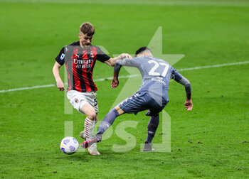 2021-05-01 - Alexis Saelemaekers of AC Milan fights for the ball against Fabio Depaoli of Benevento Calcio during the Serie A 2020/21 football match between AC Milan vs Benevento Calcio at Giuseppe Meazza Stadium, Milan, Italy on May 01, 2021 - Photo FCI / Fabrizio Carabelli - AC MILAN VS BENEVENTO CALCIO - ITALIAN SERIE A - SOCCER