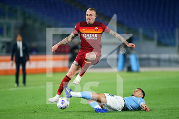 2021-05-15 - Rick Karsdorp of Roma (L) jumps over Stefan Radu of Lazio (R) during the Italian championship Serie A football match between AS Roma and SS Lazio on May 15, 2021 at Stadio Olimpico in Rome, Italy - Photo Federico Proietti / DPPI - AS ROMA VS SS LAZIO - ITALIAN SERIE A - SOCCER