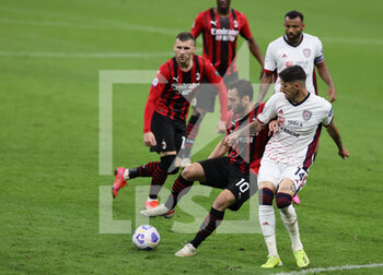 2021-05-16 - Hakan Calhanoglu of AC Milan fights for the ball against Alessandro Deiola of Cagliari Calcio during the Serie A 2020/21 football match between AC Milan vs Cagliari Calcio at Giuseppe Meazza Stadium, Milan, Italy on May 16, 2021 - Photo FCI / Fabrizio Carabelli - AC MILAN VS CAGLIARI CALCIO - ITALIAN SERIE A - SOCCER