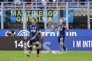 2021-08-21 - Hakan Calhanoglu of FC Internazionale celebrates after scoring a goal during the Serie A 2021/22 football match between FC Internazionale and Genoa CFC at Giuseppe Meazza Stadium, Milan, Italy on August 21, 2021 - Photo FCI / Fabrizio Carabelli - INTER - FC INTERNAZIONALE VS GENOA CFC - ITALIAN SERIE A - SOCCER