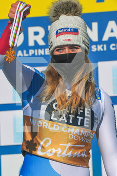 2021-02-13 - Suisse’s Corinne Suter shows her Gold Medal on the podium  - 2021 FIS ALPINE WORLD SKI CHAMPIONSHIPS - DOWNHILL - WOMEN - ALPINE SKIING - WINTER SPORTS