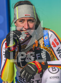 2021-02-13 - Germany’s Kira Weidle bites her Silver Medal on the podium  - 2021 FIS ALPINE WORLD SKI CHAMPIONSHIPS - DOWNHILL - WOMEN - ALPINE SKIING - WINTER SPORTS
