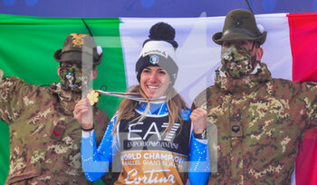 2021-02-16 - Italy‚Äôs Marta Bassino shows her Gold medal together two Alpine military who support the Italian National flag - 2021 FIS ALPINE WORLD SKI CHAMPIONSHIPS - PARALLEL GIANT SLALOM - WOMEN - ALPINE SKIING - WINTER SPORTS