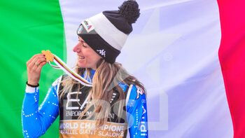 2021-02-16 - Italy‚Äôs Marta Bassino look nice her Gold medal with in background the Italian National flag - 2021 FIS ALPINE WORLD SKI CHAMPIONSHIPS - PARALLEL GIANT SLALOM - WOMEN - ALPINE SKIING - WINTER SPORTS