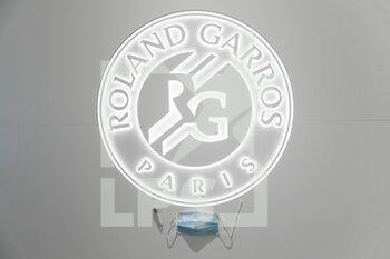 2020-09-21 - Illustration of official tennis ball Roland Garros 2020 by Wilson with Roland Garros lighting logotype pictured with chirurgical protector mask, swab sample, tube of physiological liquid under the CoVid health crisis 19 during the Roland Garros 2020, Grand Slam tennis tournament, Qualifying, on September 21, 2020 at Roland Garros stadium in Paris, France - Photo Stephane Allaman / DPPI - ROLAND GARROS 2020, GRAND SLAM - QUALIFYING - INTERNATIONALS - TENNIS
