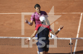 2021-05-30 - Pablo Andujar of Spain (white cap) shakes hands with Dominic Thiem of Austria after his victory during day 1 of the French Open 2021, a Grand Slam tennis tournament on May 30, 2021 at Roland-Garros stadium in Paris, France - Photo Jean Catuffe / DPPI - ROLAND-GARROS 2021, GRAND SLAM TENNIS TOURNAMENT - INTERNATIONALS - TENNIS