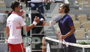2021-06-07 - Novak Djokovic of Serbia shakes hands with Lorenzo Musetti of Italy after his victory during day 9 of the French Open 2021, Grand Slam tennis tournament on June 7, 2021 at Roland-Garros stadium in Paris, France - Photo Jean Catuffe / DPPI - ROLAND-GARROS 2021, GRAND SLAM TENNIS TOURNAMENT - INTERNATIONALS - TENNIS