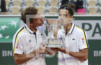 2021-06-12 - Winners Nicolas Mahut and Pierre-Hughes Herbert of France during the Men's Doubles final trophy ceremony on day 14 of Roland-Garros 2021, French Open 2021, a Grand Slam tennis tournament on June 12, 2021 at Roland-Garros stadium in Paris, France - Photo Jean Catuffe / DPPI - ROLAND-GARROS 2021, FRENCH OPEN 2021, A GRAND SLAM TENNIS TOURNAMENT - INTERNATIONALS - TENNIS