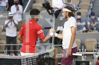 2021-06-13 - Novak Djokovic of Serbia shakes hands with Stefanos Tsitsipas of Greece after winning the men's final during day 15 of Roland-Garros 2021, French Open 2021, a Grand Slam tennis tournament on June 13, 2021 at Roland-Garros stadium in Paris, France - Photo Jean Catuffe / DPPI - ROLAND-GARROS 2021, FRENCH OPEN 2021, A GRAND SLAM TENNIS TOURNAMENT - INTERNATIONALS - TENNIS