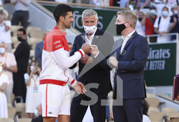 2021-06-13 - Winner Novak Djokovic of Serbia, President of French Tennis Federation FFT Gilles Moretton, trophy presenter Jim Courier during the trophy ceremony of the men's final on day 15 of Roland-Garros 2021, French Open 2021, a Grand Slam tennis tournament on June 13, 2021 at Roland-Garros stadium in Paris, France - Photo Jean Catuffe / DPPI - ROLAND-GARROS 2021, FRENCH OPEN 2021, A GRAND SLAM TENNIS TOURNAMENT - INTERNATIONALS - TENNIS
