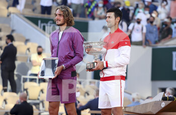 2021-06-13 - Finalist Stefanos Tsitsipas of Greece, winner Novak Djokovic of Serbia during the trophy ceremony of the men's final on day 15 of Roland-Garros 2021, French Open 2021, a Grand Slam tennis tournament on June 13, 2021 at Roland-Garros stadium in Paris, France - Photo Jean Catuffe / DPPI - ROLAND-GARROS 2021, FRENCH OPEN 2021, A GRAND SLAM TENNIS TOURNAMENT - INTERNATIONALS - TENNIS