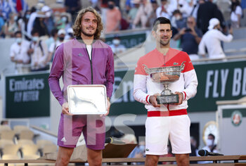 2021-06-13 - Finalist Stefanos Tsitsipas of Greece, winner Novak Djokovic of Serbia during the trophy ceremony of the men's final on day 15 of Roland-Garros 2021, French Open 2021, a Grand Slam tennis tournament on June 13, 2021 at Roland-Garros stadium in Paris, France - Photo Jean Catuffe / DPPI - ROLAND-GARROS 2021, FRENCH OPEN 2021, A GRAND SLAM TENNIS TOURNAMENT - INTERNATIONALS - TENNIS